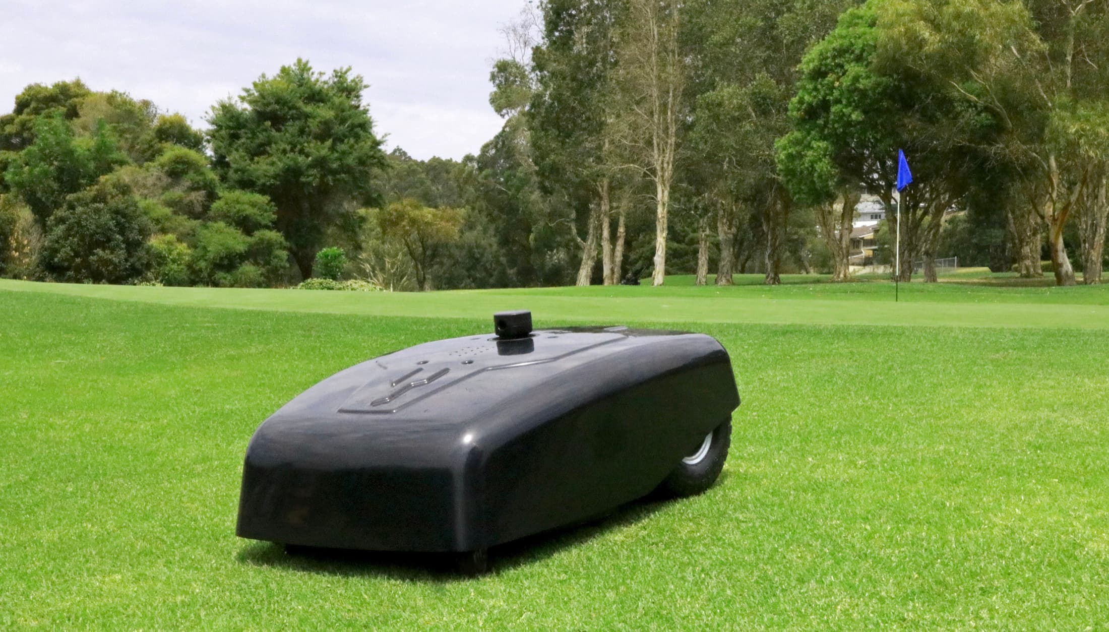 Elite Robotics autonomous mower operating on a golf course during an outdoor demonstration.